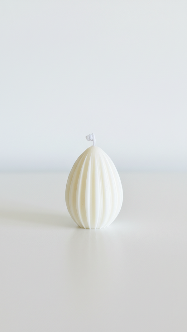 Minimalist Easter table decor featuring ivory soy wax bunny and egg-shaped candles.