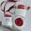 Rose & Romance Candle in glass jar with wax rose top and rose vanilla fragrance