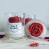 Rose & Romance Candle in glass jar with wax rose top and rose vanilla fragrance
