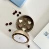 Hand-poured espresso scented soy candle in a minimalist tin jar featuring six decorative wax heart toppers, made in Perth, WA.