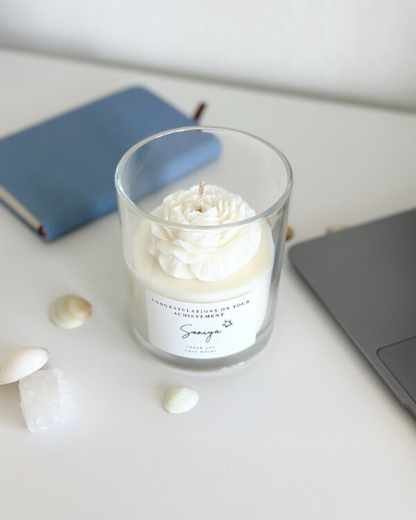 A custom gift peony candle featuring a white sculptural flower in a clear glass jar - Krisha Essence Perth