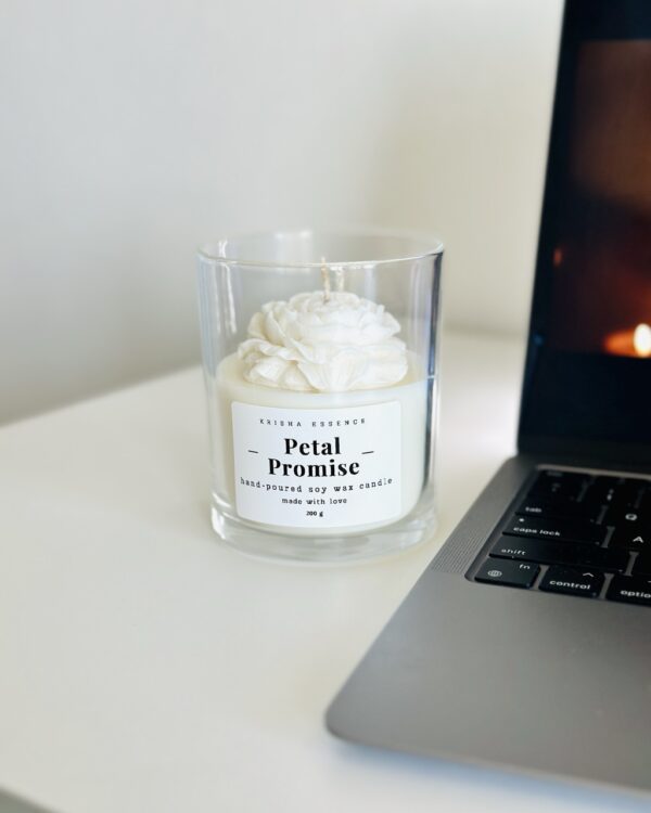 Close-up detail of a hand-poured sculptural wax peony on top of a luxury soy candle
