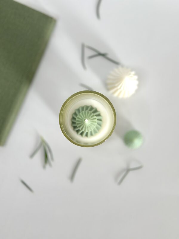 Krisha Essence Holiday Charm candle trio lit on a festive summer table setting