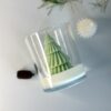 Eco-friendly soy wax candle with festive pine design for holiday decor