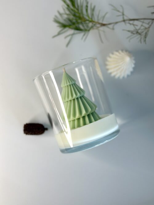 Eco-friendly soy wax candle with festive pine design for holiday decor