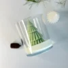 Nordic pine christmas candle in glass jar, sculpted tree design with pine sprig and pinecone