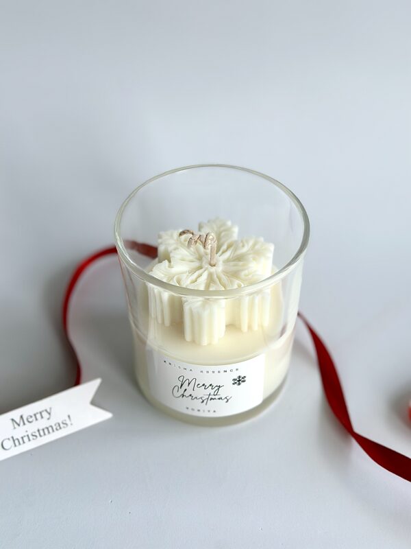 Festive soy Christmas candle Australia featuring detailed white snowflake top.