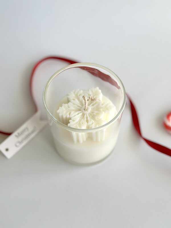 Handmade Christmas soy candle Australia with snowflake design in clear glass jar.