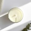 Detailed view of a clean-burning natural soy wax candle in a recyclable clear glass jar, ideal for sustainable relaxation gifts for her.