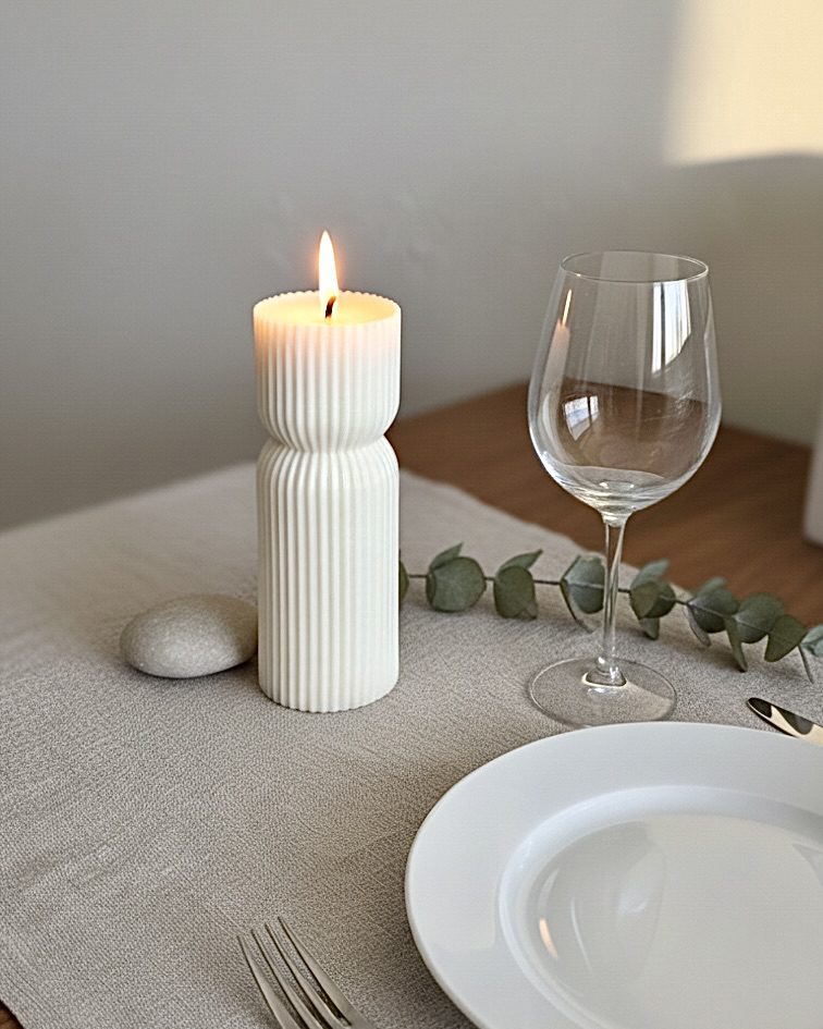 Unique Mother's Day gifts styled on a dining table; an ivory sculptural pillar candle creating a modern minimalist home decor aesthetic in a Perth home.