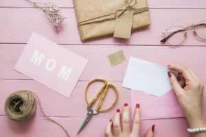 Luxury Mother's Day candle gift set with hand-poured soy candles in clear glass jars, styled with pink florals for a home spa experience in Perth.
