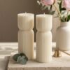 Sculptural ribbed pillar candle wedding favours displayed in the Krisha Essence Perth studio — sustainable soy wax bonbonniere for Australian brides