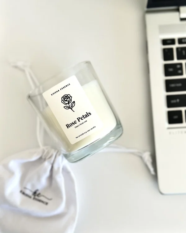 Overhead view of Krisha Essence Rose Petals minimalist glass jar candle and branded fabric gift bag, hand-poured in Perth using natural soy wax.