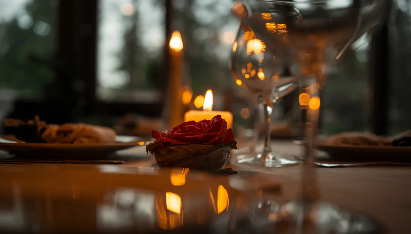 Styled dinner table with a romantic rose scented candle centrepiece